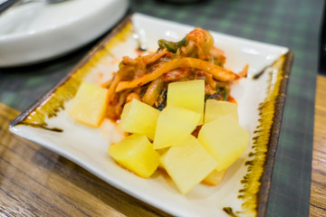 Kimchi in the plate on table , korean food .