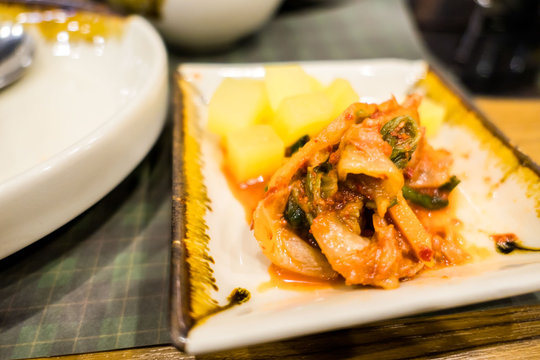 Kimchi in the plate on table , korean food .