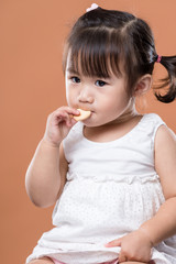 Little girl eating her cracker