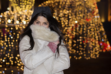 young beautiful woman  on the street at night.Christmas street decoration