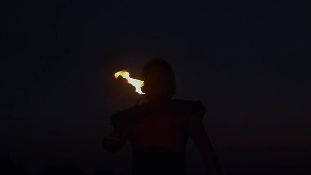 Fantastic Show at Sunset. Circus artist Spit the Fire in slow motion.