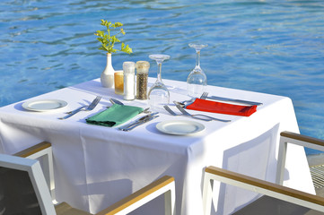 Served tables of the restaurant on the beach