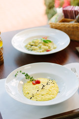 Italian food - delicious traditional risotto in a white plate.