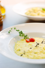Italian food - delicious traditional risotto in a white plate.