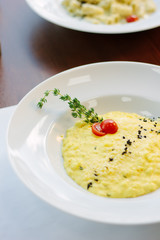 Italian food - delicious traditional risotto in a white plate.