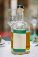 Glass bottle with liquid - wine or olive oil with label for your text.