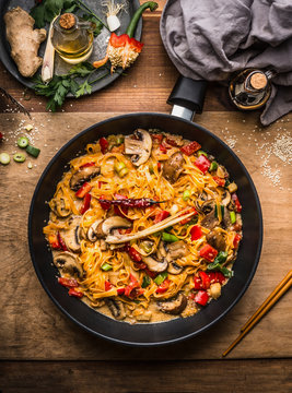 Tasty Vegetarian Fried Noodles Pan With Vegetables And  Creamy Pasta Sauce On Wooden Background, Top View