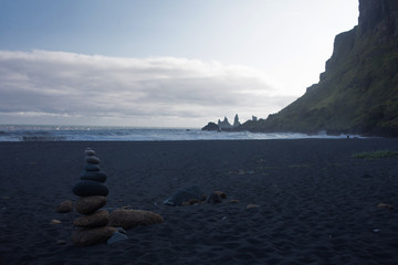 pyramid of pebbles on black volcanic beach in Iceland