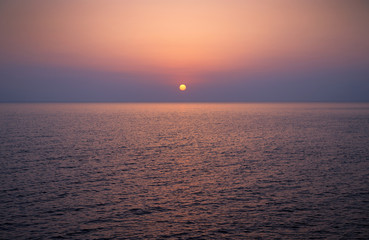 Brightly colored sunset over the calm Mediterranean Sea. Drone Point of View . Night	