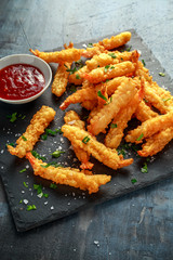Fried Shrimps tempura with sweet chili sauce on black board stone