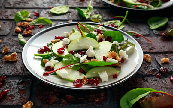 Homemade Autumn Apple Cranberry Salad with walnut, feta cheese and vegetables