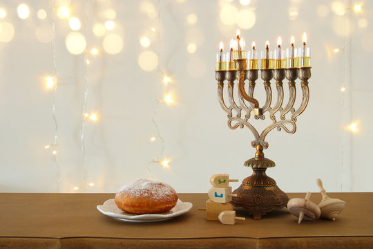Image of jewish holiday Hanukkah background with traditional spinnig top, menorah (traditional candelabra)
