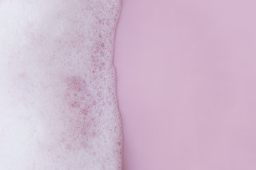 white foam bubbles on pink background