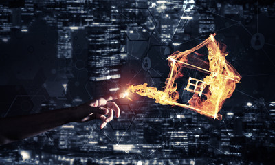 Burning fire house icon against night city background