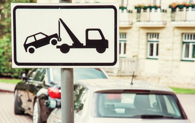Tow away sign, no parking place, yellow filter