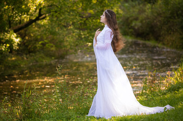 Princess with long hair in white long dress