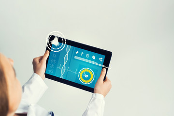 Close of female doctor hands working with tablet pc computer