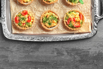 Delicious crispy tarts with broccoli on metal tray