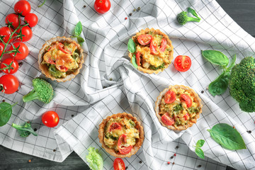 Delicious crispy tarts with broccoli on napkin