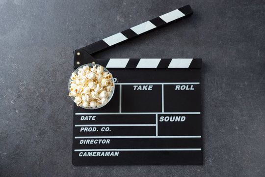 popcorn with movie maker or clapperboard cinema.