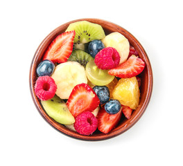Bowl with delicious fruit salad on white background