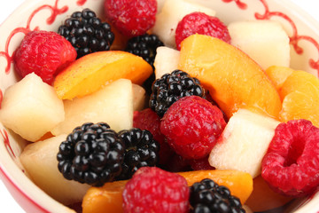 Bowl with delicious fruit salad, closeup
