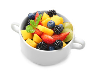 Bowl with delicious fruit salad on white background