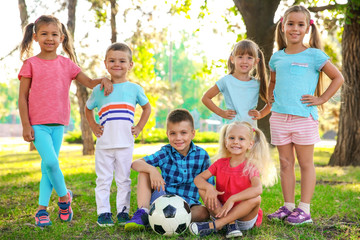 Cute little children with ball in park