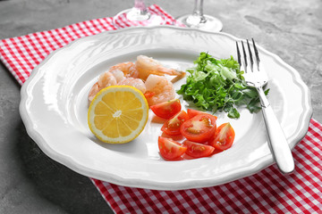 Plate with fresh tasty shrimp salad on table