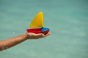 toy ship on the tropical beach, vacation. Traveler dreams concept