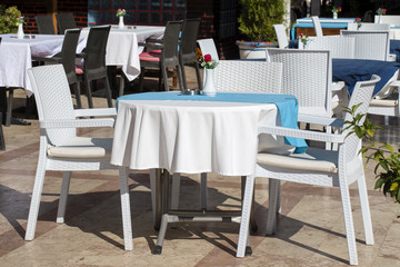 Fototapeta na wymiar Table and chairs in empty cafe near the beach. Kemer, Turkey