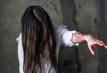 Ghost woman or Zombie holding knife reach arm