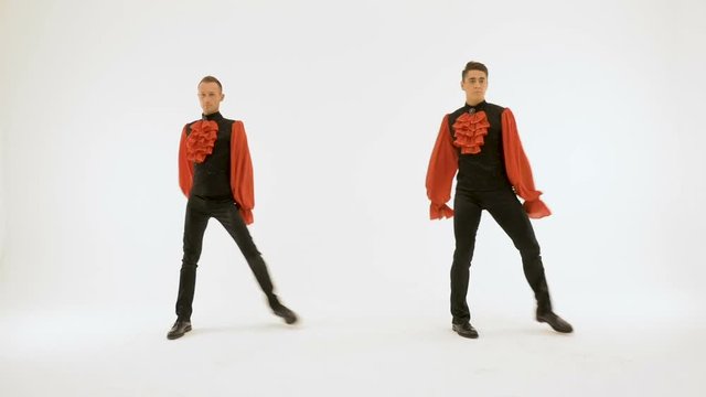Two men in black suits dance beautifully on a white background.