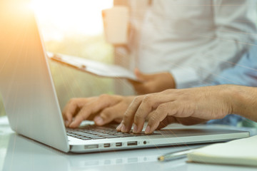 Fototapeta premium Businessmen use laptops to present reports to the chief,Close up business man use laptop Selective focus on hand.