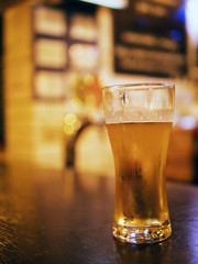 A glass of beer on the bar