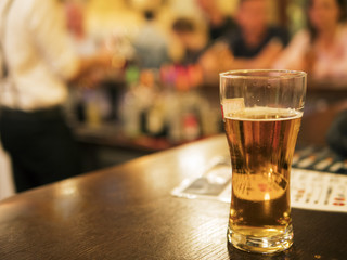 A glass of beer on the bar