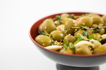 Marinated olives with garlic and herbs in bowl
