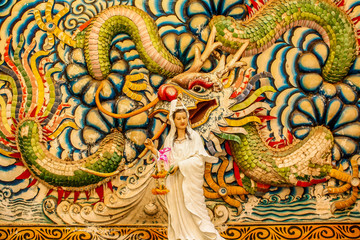 Statue of Guan Yin Dragon background
