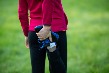 Stretching woman legs on free natural background