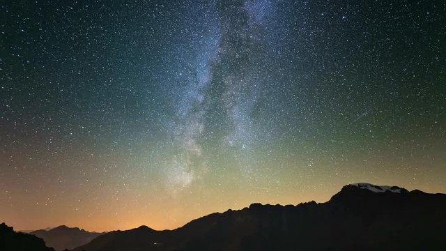 Meteor explosion, meteor shower and stardust smoke trail in night sky, time lapse of the Milky Way and the starry sky over the Alps.