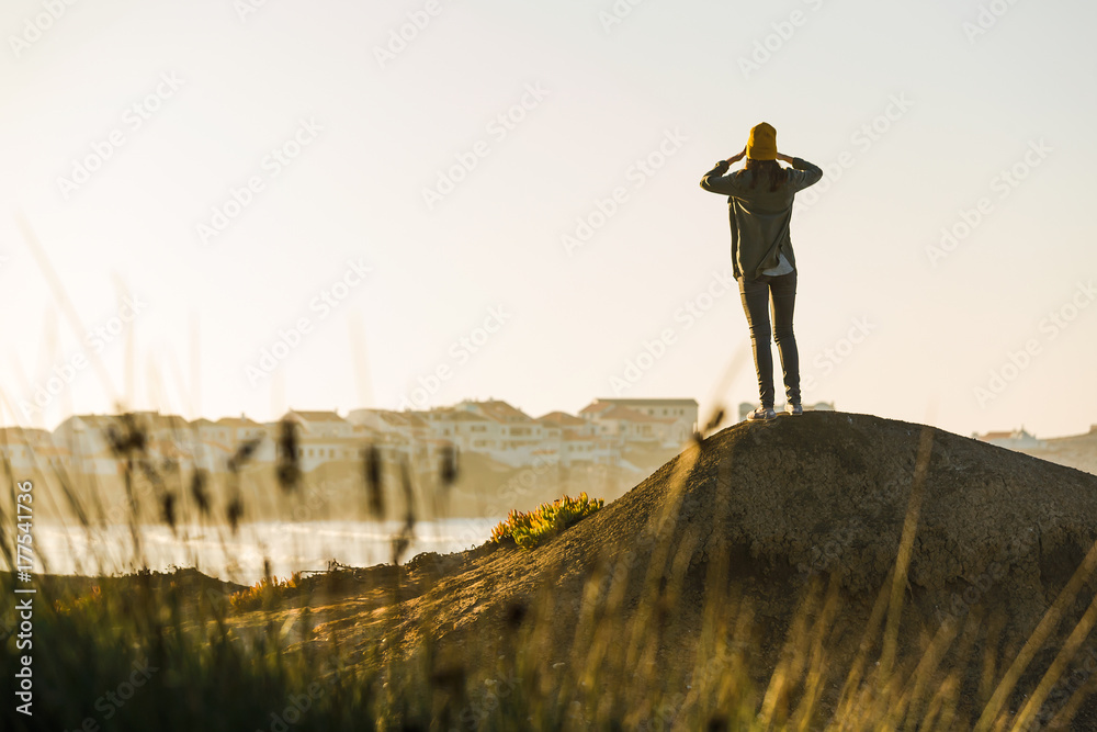 Wall mural Woman over the cliff