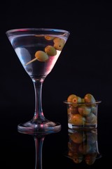 Cocktail martini with olives on table