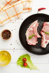 Raw pork chops on grill pan