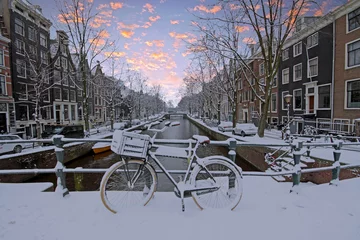 Schilderijen op glas Snowy Amsterdam in the Netherlands in winter © Nataraj