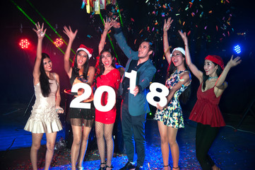 Group of people dancing at night club with santa hat christmas holidays party friendship relaxing celebrating new year 2018..