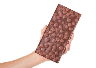 chocolate bar with nuts in hand isolated on white background
