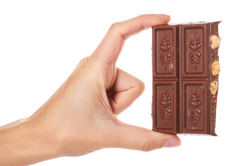 chocolate bar with nuts in hand isolated on white background