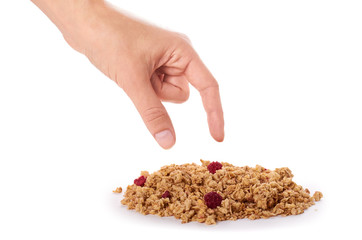 homemade granola with dried fruits in hand isolated on white background