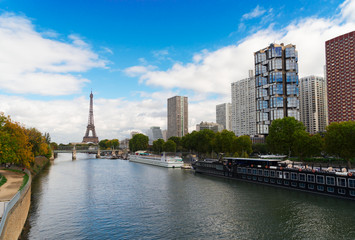 Obraz premium Eiffel Tower with moden houses over Seine, Paris, France