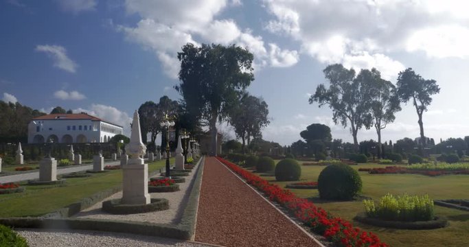 Panning shot of beautiful Bahai garden with the Mansion of Bahji in the distance. Acre, Israel